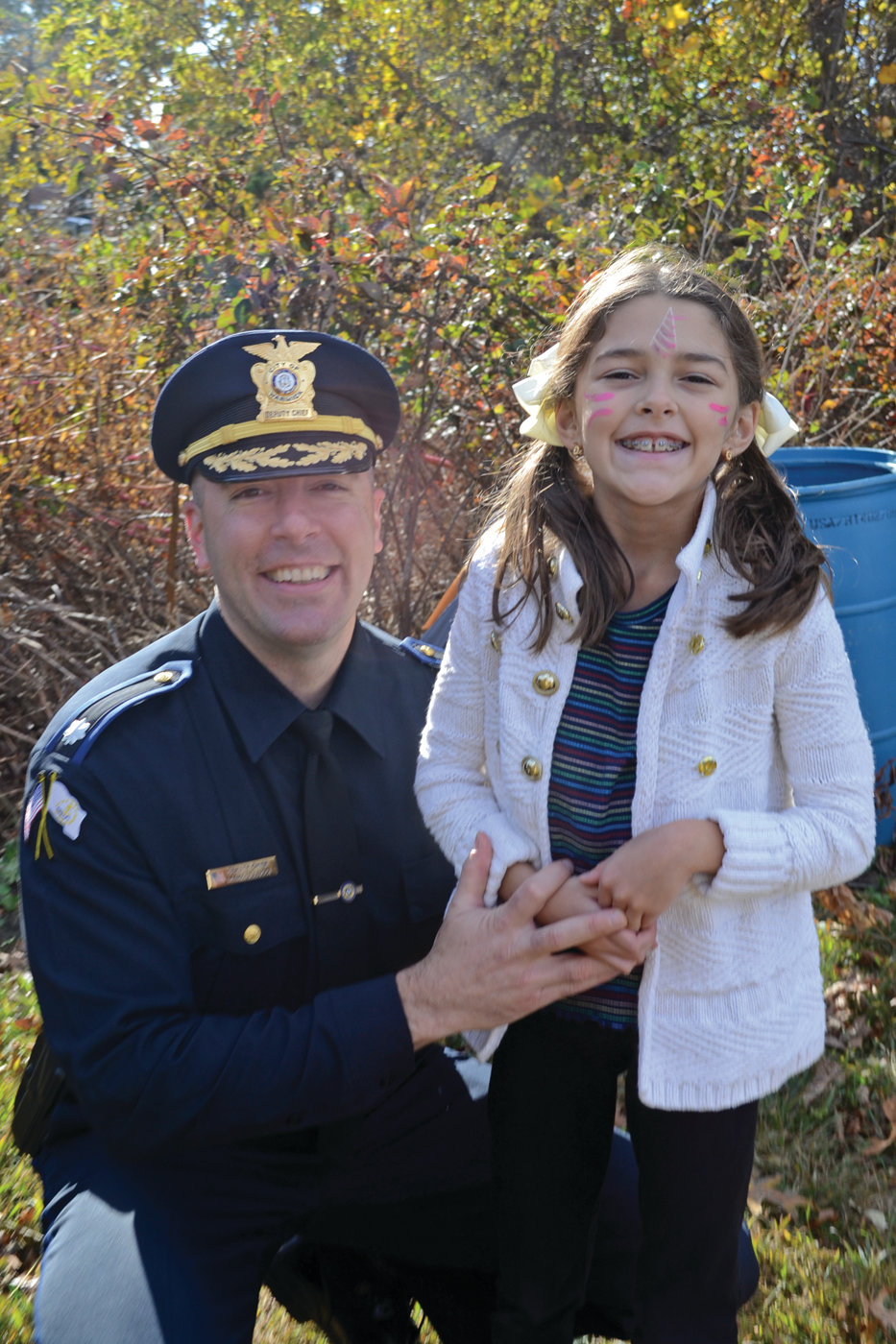 BRING YOUR DAUGHTER TO WORK DAY: Warwick Deputy Police Chief Mark Ulucci with his daughter, Sabrina, who enjoyed a free face painting on Saturday at the park celebration.